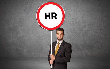 Young business person holdig traffic sign