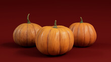 Three Pumpkins On A Dark Red Colored Background. Autumn Themed Wallpaper.