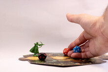 A Hand Throwing Rpg Dices On A Adventure Tile