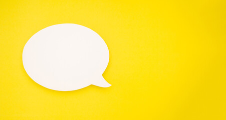 A blank white speech bubble over a light yellow background