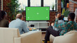 © DC Studio - People cheering at football game match on greenscreen, using blank chroma key template to watch soccer team in championship. Sport fans looking at isolated mockup copyspace background.
