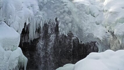 Wall Mural - Frozen winter siberian waterfall. Ice formation with white snow. 