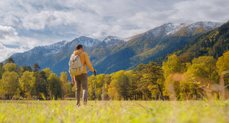 Wall Mural - trip to Caucasus mountains, Arkhyz, Teberdinsky reserve. concept of discovery and exploration of wild places in early autumn. Man hiking in mountains with backpack and photo camera