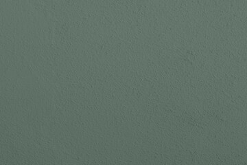 Saturated pastel greenish gray colored low contrast Concrete textured background. Empty colorful wall texture with copy space for text overlay and mockups. 2023, 2024 color trend