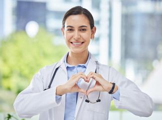 Wall Mural - Heart, hand and icon with happy doctor in medical clinic or hospital. Happy, health and safety in the field of medicine and healthcare while love for her career, job or work while ready to help