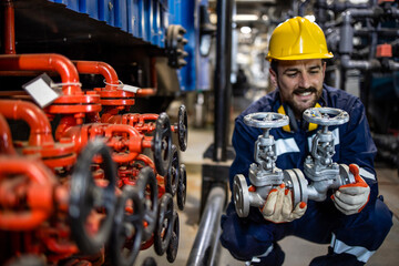 Wall Mural - Industrial maintenance service and experienced engineer changing pipe valves in oil refinery plant.