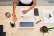 © Westend61 - Businesswoman with tea cup writing in note pad at home office
