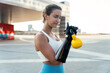 © Westend61 - Young woman with arm prosthesis exercising with kettlebell