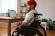 © Westend61 - Thoughtful man in wheelchair with laptop at home