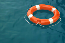 Orange Lifebuoy Ring Floating On Sea