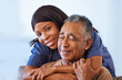 © Beaunitta Van Wyk/peopleimages.com - Nurse hug, senior man and healthcare support in consultation in home, help with health from doctor and medical communication in retirement in house. Portrait of African caregiver working at clinic