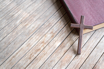 Wall Mural - Wooden cross on top of a leather cover bible. Copy space.
