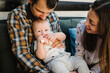 © Serhii - Portrait of young smiling family with son playing with toy. Happy family, parenthood and people concept - mother, father with baby at home.