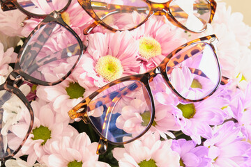 Poster - several trendy modern eye glasses on flowers. trendy eyeglasses