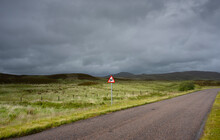 UK, Scotland, Storm Clouds Above Green Landscape And Country Road