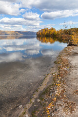 Wall Mural - baikal lake in september sunny day. view from the shore with yellow fallen leaves to natural landmar
