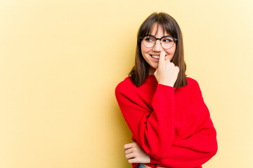 Young caucasian woman isolated on yellow background relaxed thinking about something looking at a copy space.