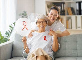 Smiling women with red satin ribbon