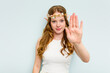 © Asier - Young elf woman isolated on blue background standing with outstretched hand showing stop sign, preventing you.
