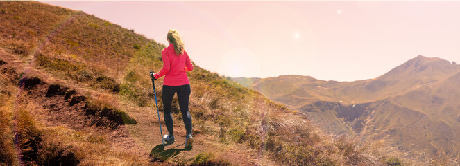 Wall Mural - Sporty woman hiking the mountain