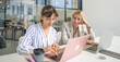 © Nassorn - Businesswoman is working in office discussion with colleague using laptop computer and wireless technology. Modern woman and coworker teamwork meeting, brainstorming success business strategy.