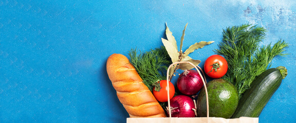 Different food in paper bag. Top view. Copy space. Banner