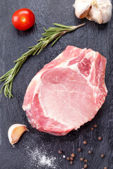 Wall Mural - Raw meat bone steak with spices. Top view, Closeup