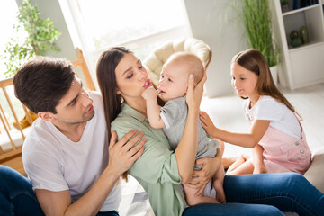 Wall Mural - Photo of sweet cute couple two kids sitting carpet soothing little baby indoors house home room