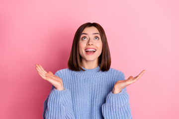 Sticker - Portrait of astonished positive person opened arms palm look up empty space isolated on pink color background