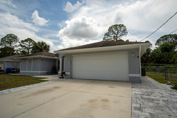 Wall Mural - Wide garage double door and concrete driveway of new modern american house