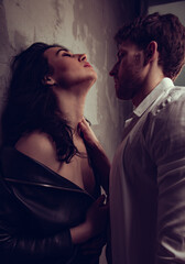 Sexy natural couple portrait. Man sexual toching and embracing his sensual beautiful girlfriend neck with much emotion. Closeup toned