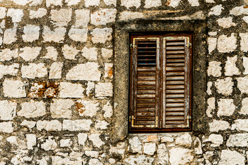 Wall Mural - Stone wall and window with closed wooden shutters