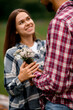 © fesenko - Close-up of wildflowers in the hand of man which he gives to smiling woman