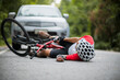 © VStudio - An Asian mountain biker was hit by a car on the road. A mountain biker was injured in a collision with a car on the road. Concept reduces accidents from using cars on the road. Selective focus.
