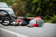 © VStudio - An Asian mountain biker was hit by a car on the road. A mountain biker was injured in a collision with a car on the road. Concept reduces accidents from using cars on the road. Selective focus.