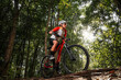 © VStudio - Mountain bikers ride MTB, mountain bike downhill to the extreme. Asian man rides MTB, mountain bike downhill in the wild to extremes. Extreme Sport and MTB, mountain bike downhill Concept.