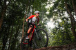 © VStudio - Mountain bikers ride MTB, mountain bike downhill to the extreme. Asian man rides MTB, mountain bike downhill in the wild to extremes. Extreme Sport and MTB, mountain bike downhill Concept.