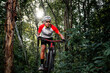 © VStudio - Mountain bikers ride MTB, mountain bike downhill to the extreme. Asian man rides MTB, mountain bike downhill in the wild to extremes. Extreme Sport and MTB, mountain bike downhill Concept.