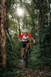 © VStudio - Mountain bikers ride MTB, mountain bike downhill to the extreme. Asian man rides MTB, mountain bike downhill in the wild to extremes. Extreme Sport and MTB, mountain bike downhill Concept.