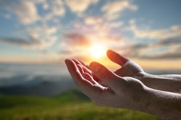 Christian person hands pray on nature background..