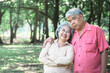 © Anatta_Tan - Asian elderly couple Standing under a big tree, they are happy,  to elderly relaxation in the park and happiness in retirement concept.