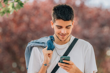 Sticker - young man looking at mobile phone in the street