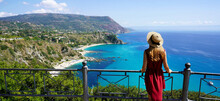 Traveling In Italy. Panoramic View Of Elegant Woman With Hat In Capo Vaticano In The Coast Of The Gods, Calabria, Italy.