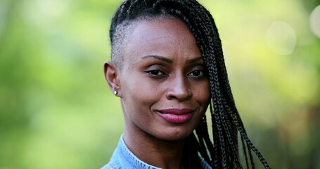 Wall Mural - African person portrait smiling standing outside, Black woman