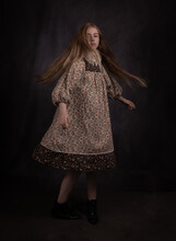 Fine Art Portrait Of A Young Woman In Vintage Dress Dancing And Twirling