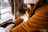 Fototapeta Konie - Cute young girl having fun in the winter park with their dog on bright day.Woman are relaxing