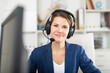© JackF - Portrait of smiling young woman helpline operator with headphones during work in call center