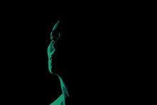 Green Woman Face Silhouette On The Black Background