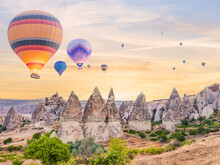 Hot Air Balloons Flying Over Fairy Chimney Valley With Background Of Sunrise Sky At Goreme Cappadocia Turkey