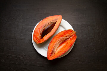 Wall Mural - Mexican fruit called mamey on dark background